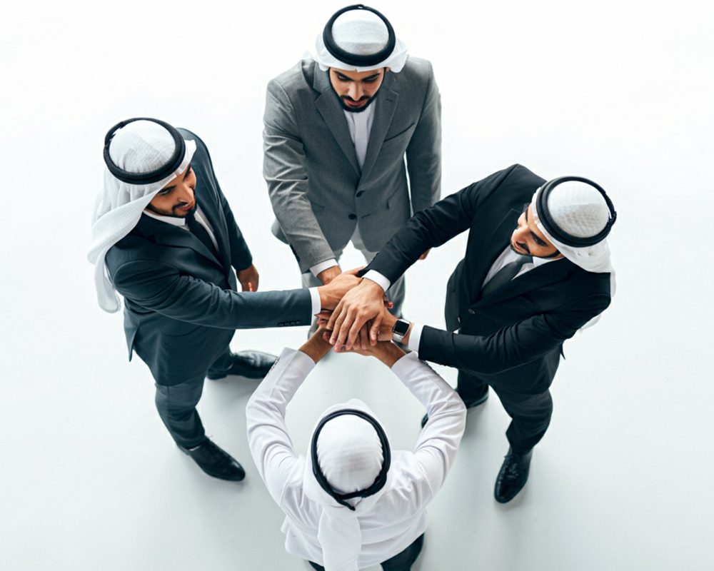 group-arabic-men-with-their-hands-together-white-background-top-view